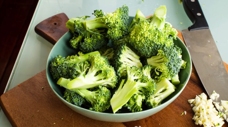 green broccoli on brown wooden chopping board