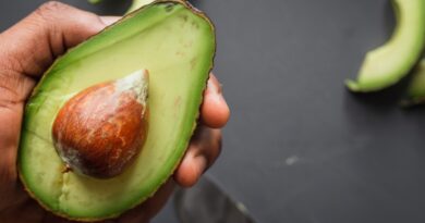 person holding green and brown sliced fruit