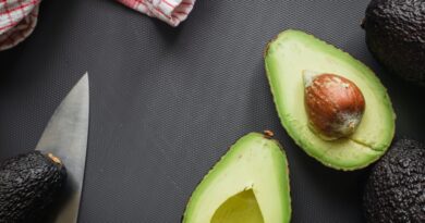 sliced avocado fruit on black textile